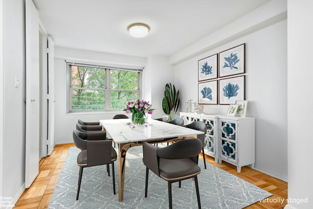 dining room featuring light parquet floors