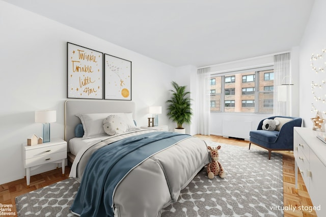 bedroom with radiator heating unit and light parquet floors