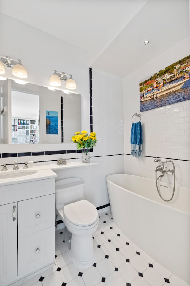 bathroom with vanity, toilet, and a bathing tub