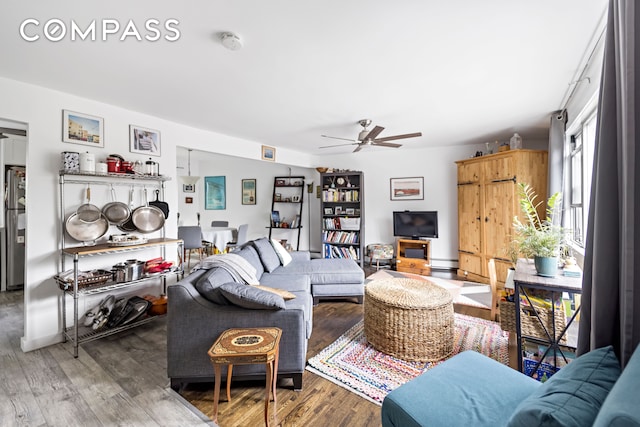 living room with ceiling fan and wood-type flooring