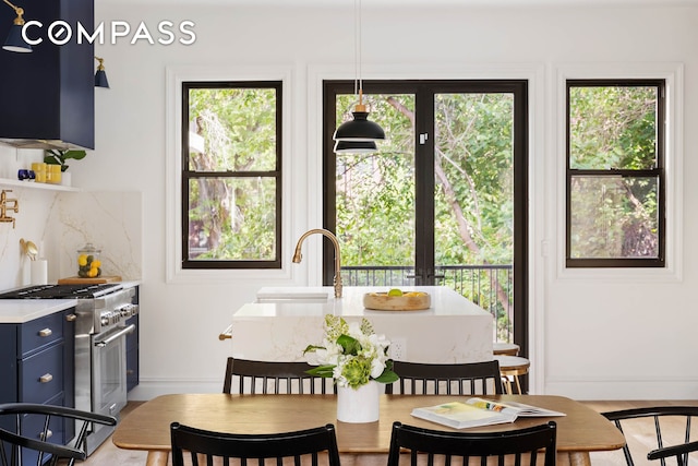 dining room featuring sink and hardwood / wood-style flooring