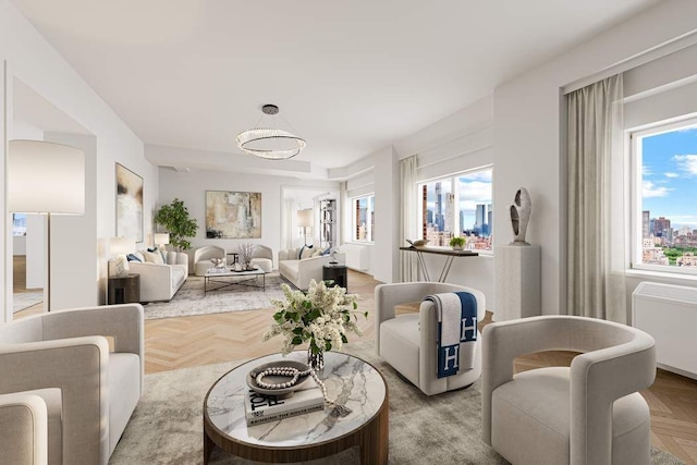 living room featuring light parquet floors, radiator heating unit, and plenty of natural light