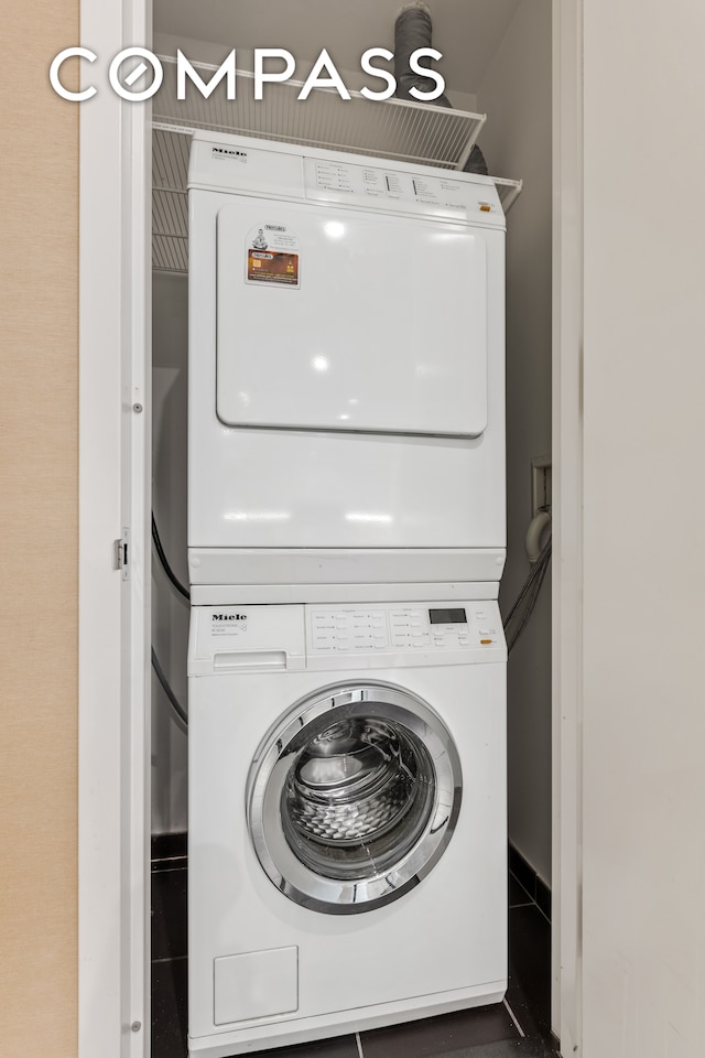 clothes washing area with stacked washer and dryer