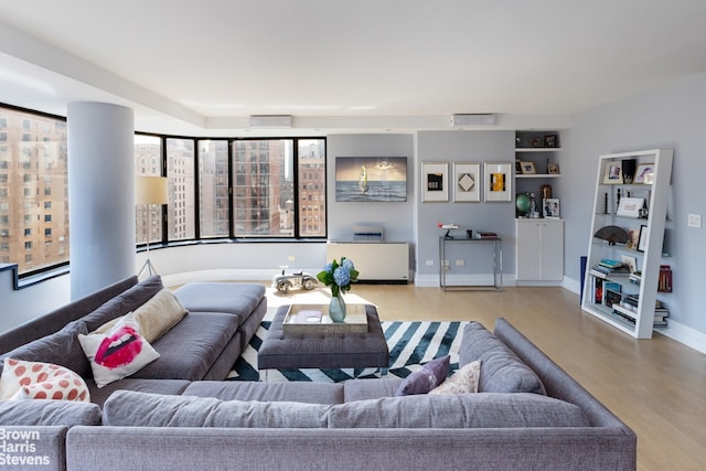 living room with plenty of natural light and light hardwood / wood-style floors