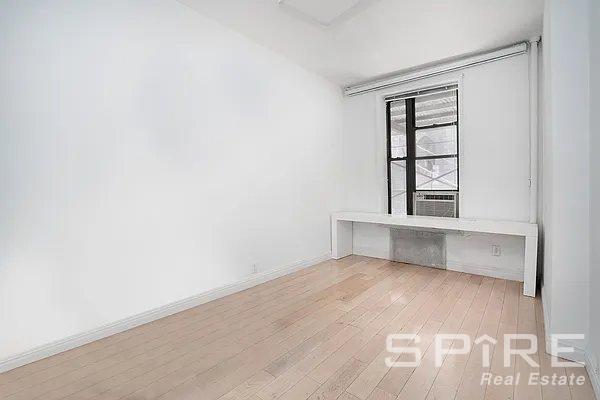 empty room with light wood-type flooring and cooling unit