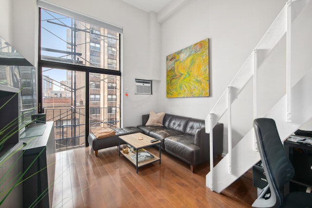 living room with wood-type flooring and a wall mounted AC