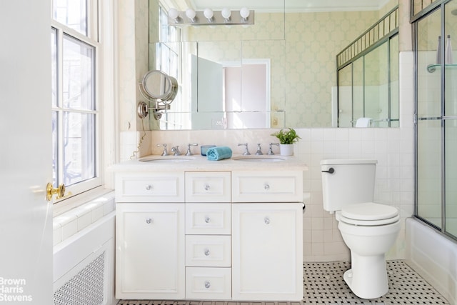 full bathroom with vanity, toilet, a healthy amount of sunlight, and enclosed tub / shower combo