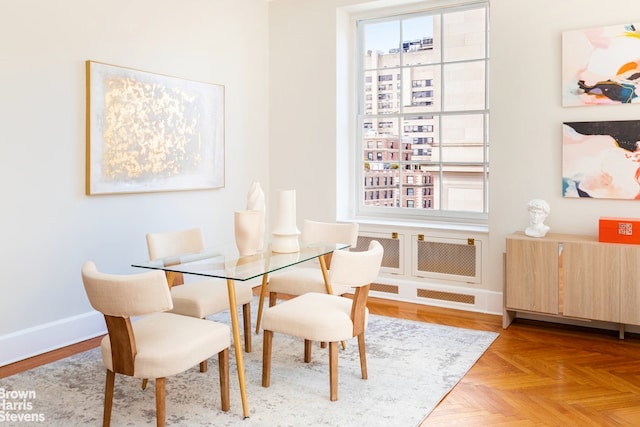 dining space with light parquet flooring