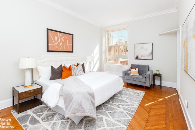 bedroom with crown molding and parquet floors