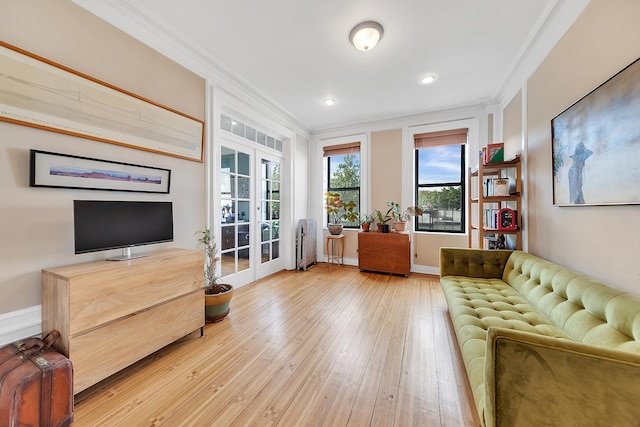 living room featuring radiator heating unit, light hardwood / wood-style flooring, french doors, and ornamental molding