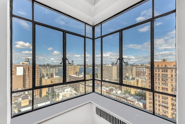 unfurnished sunroom with radiator heating unit