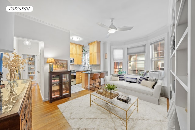 living room featuring cooling unit, crown molding, light hardwood / wood-style flooring, and ceiling fan