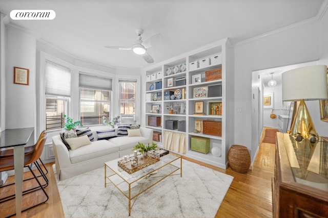 living area featuring ceiling fan, crown molding, and light hardwood / wood-style flooring