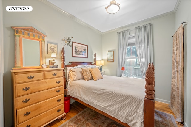 bedroom with crown molding and wood-type flooring