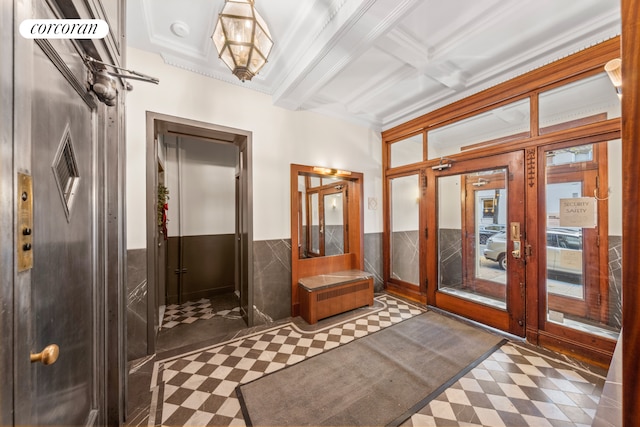 entryway with french doors, crown molding, and beam ceiling