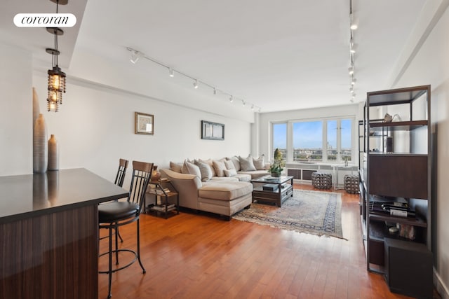 living room featuring track lighting and hardwood / wood-style flooring