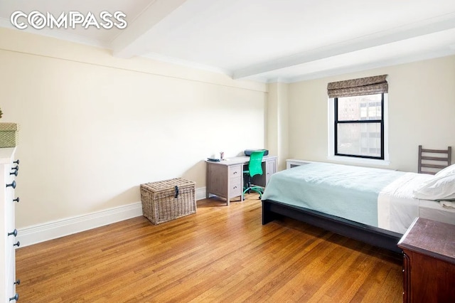 bedroom featuring light wood-type flooring and beamed ceiling