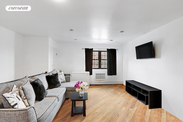 living room with light hardwood / wood-style floors and a baseboard radiator