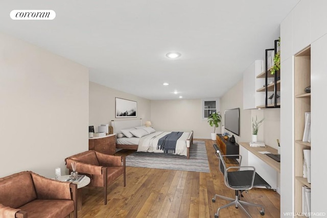 bedroom featuring light hardwood / wood-style flooring and built in desk