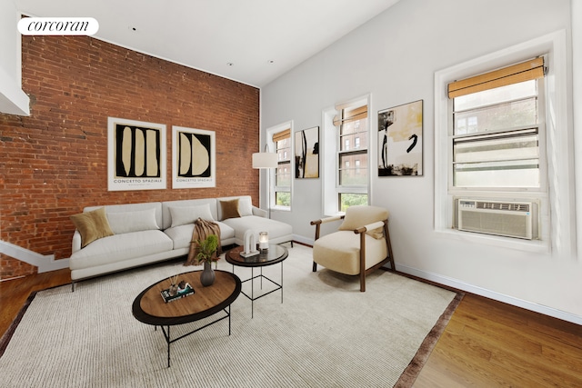 living room featuring cooling unit, hardwood / wood-style flooring, and a healthy amount of sunlight