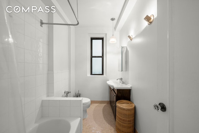 bathroom featuring tile patterned floors, vanity, a bath, and toilet