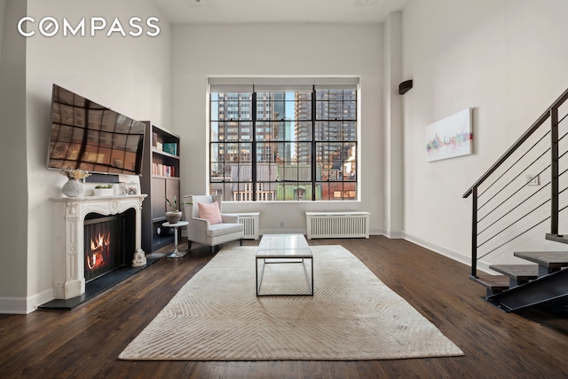 sitting room with dark hardwood / wood-style flooring