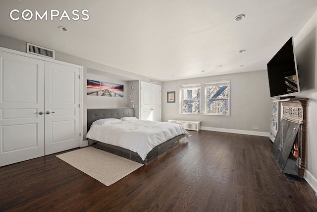 bedroom featuring radiator heating unit, a closet, and dark hardwood / wood-style flooring