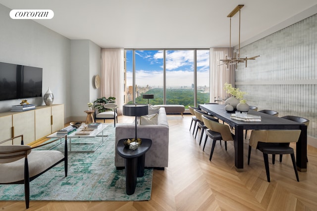 living room with light parquet flooring and an inviting chandelier