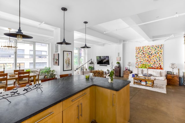 kitchen featuring dark tile patterned flooring, decorative light fixtures, an inviting chandelier, and beam ceiling