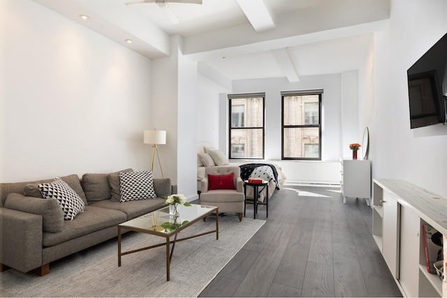 living room featuring beamed ceiling and dark hardwood / wood-style flooring