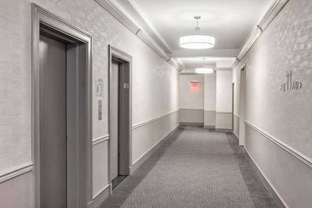 corridor featuring ornamental molding and elevator