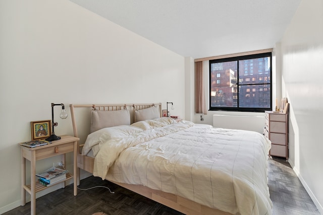 bedroom with dark parquet flooring