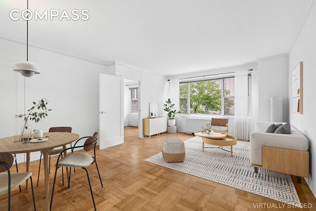 living room featuring crown molding and light parquet flooring