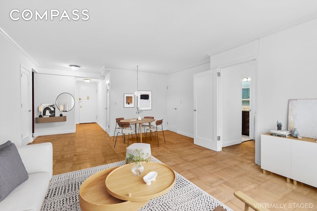 living room featuring crown molding and parquet floors