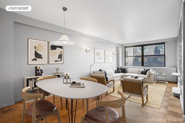 dining space featuring light parquet floors