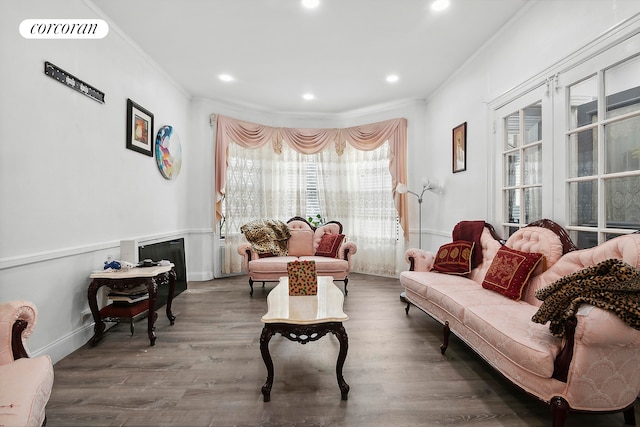 living area featuring crown molding and wood-type flooring