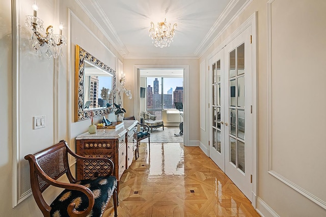 corridor with an inviting chandelier, french doors, crown molding, and light parquet floors