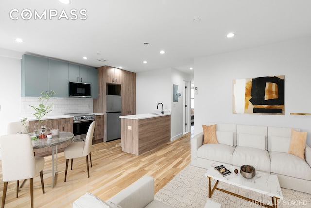 living room with sink and light hardwood / wood-style floors