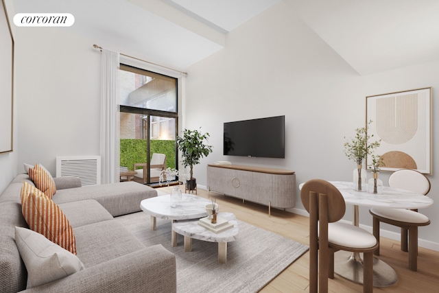 living room with vaulted ceiling and light hardwood / wood-style floors