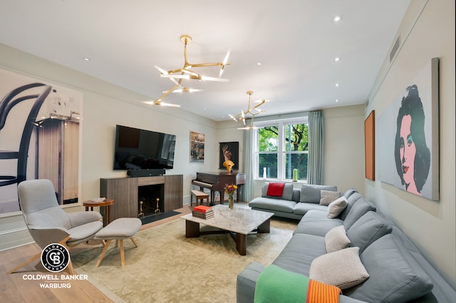 living room featuring light wood-type flooring and a notable chandelier