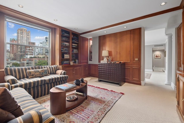 carpeted living room featuring ornamental molding and ornate columns