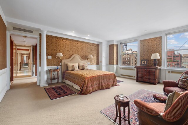 carpeted bedroom featuring ornate columns