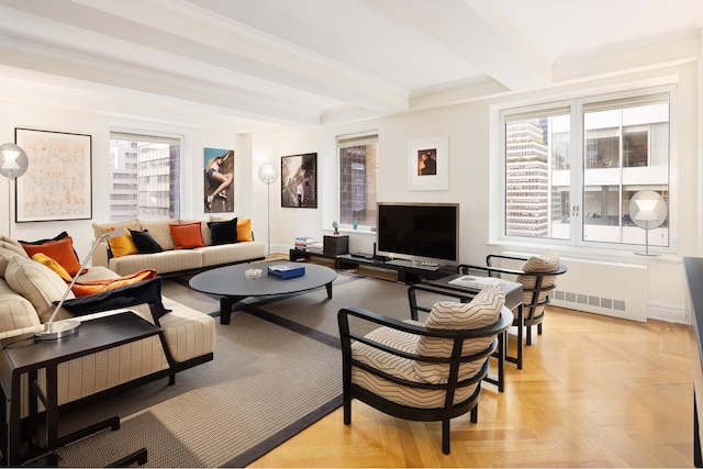 living room featuring beamed ceiling, ornamental molding, and a wealth of natural light