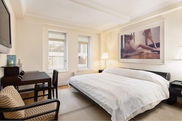 bedroom featuring ornamental molding, beamed ceiling, and hardwood / wood-style flooring