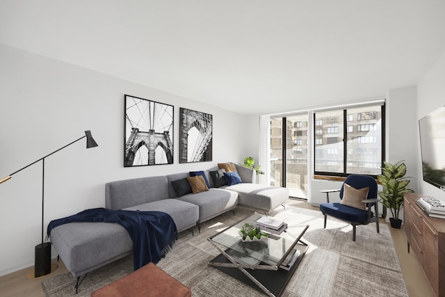 living room with floor to ceiling windows and light hardwood / wood-style floors