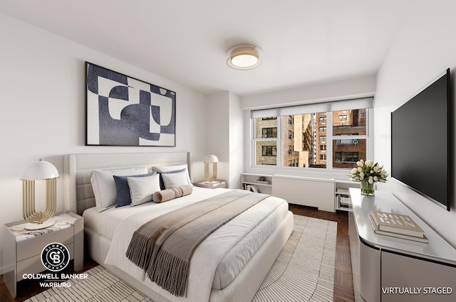 bedroom with wood-type flooring and radiator heating unit