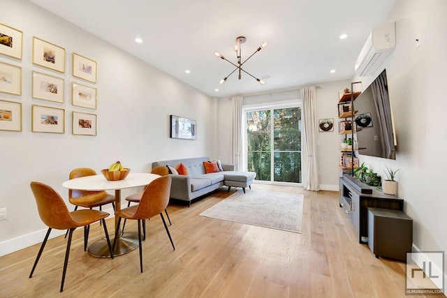 interior space featuring a wall mounted AC, a notable chandelier, and light wood-type flooring