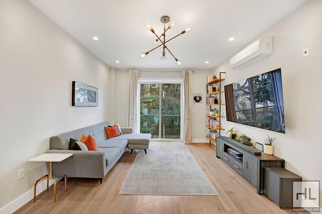 living room with light wood-type flooring, an AC wall unit, and a chandelier