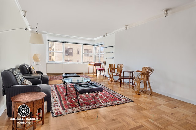 living room with crown molding and parquet floors