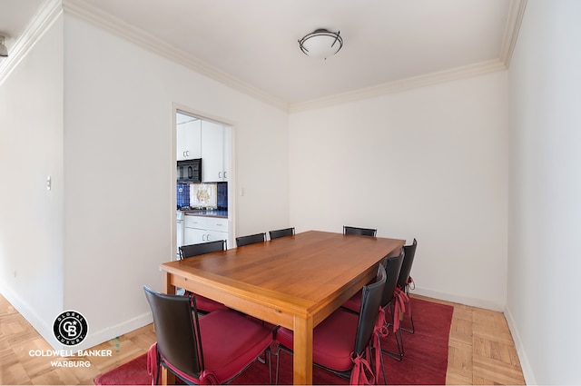 dining space with parquet flooring and ornamental molding